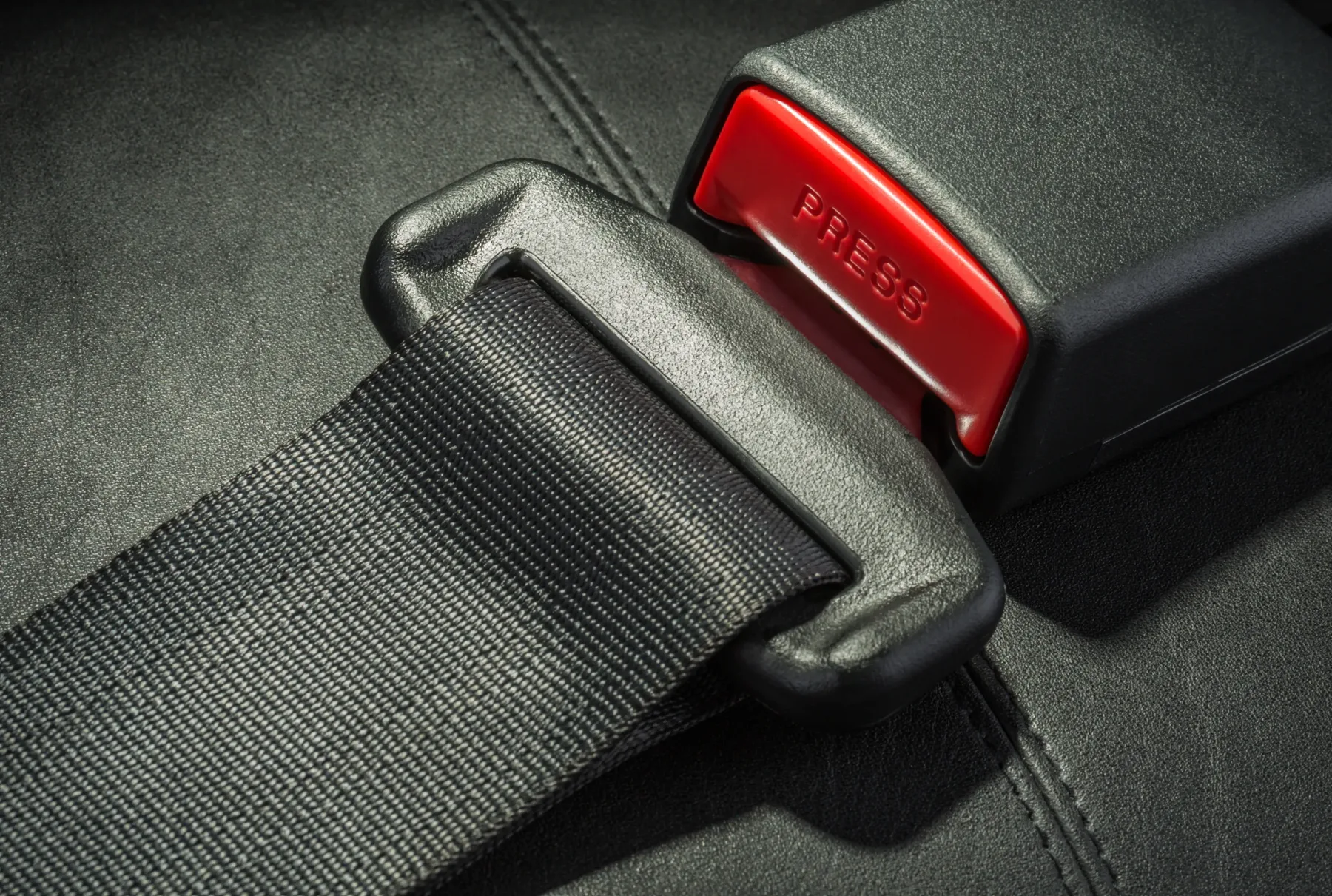 Seat belt webbing, tongue plate and red release buckle assembled on an automotive seat
